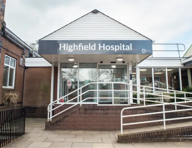 Highfield Hospital entrance with ramp access and signage.